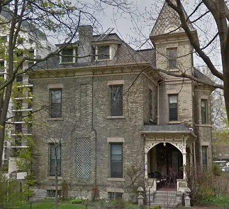 A large brick house with a tower on top of it