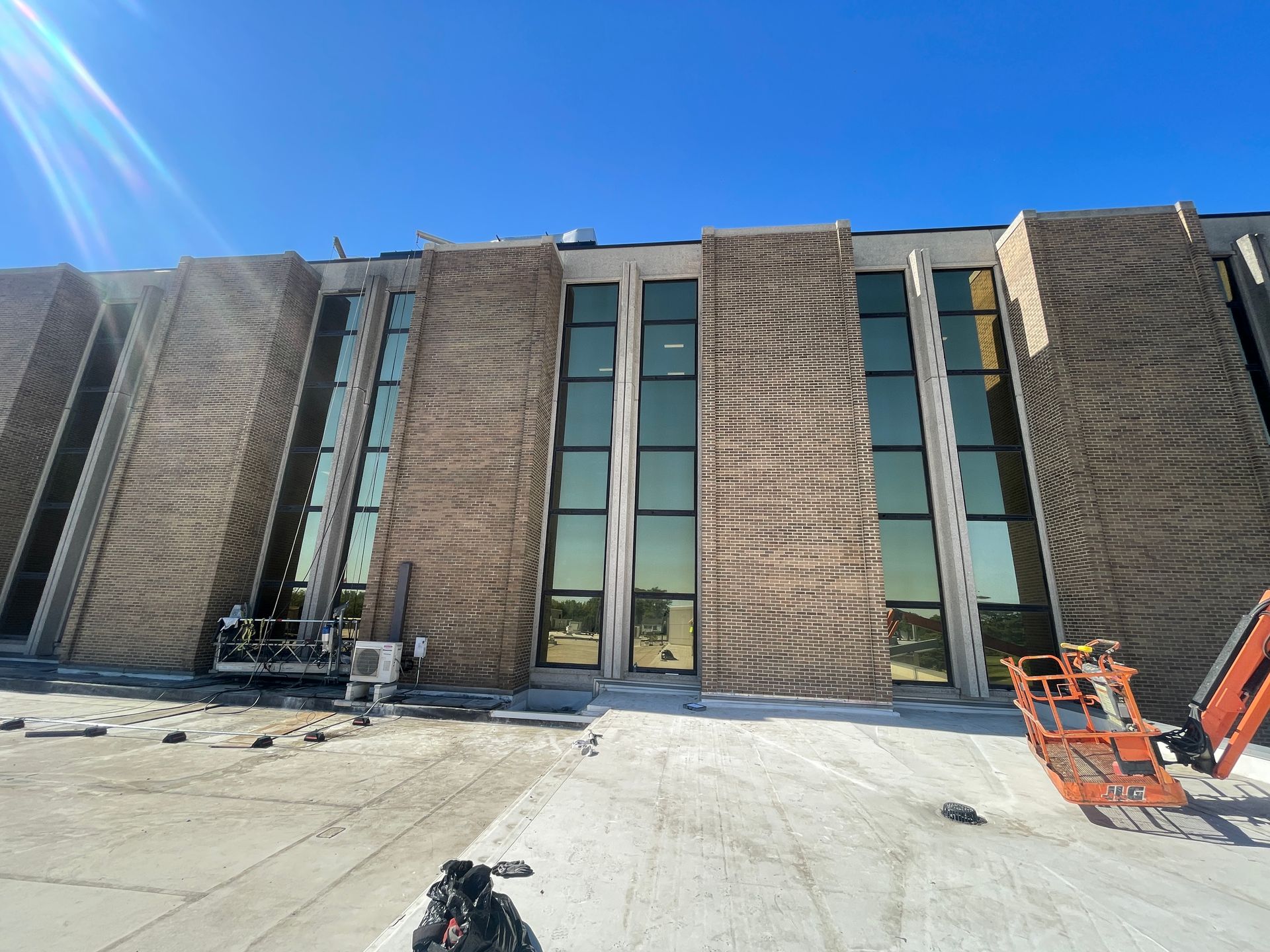 A large brick building with a lot of windows is being built.