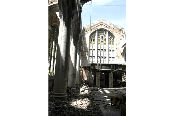 A large building with a lot of windows is being demolished.