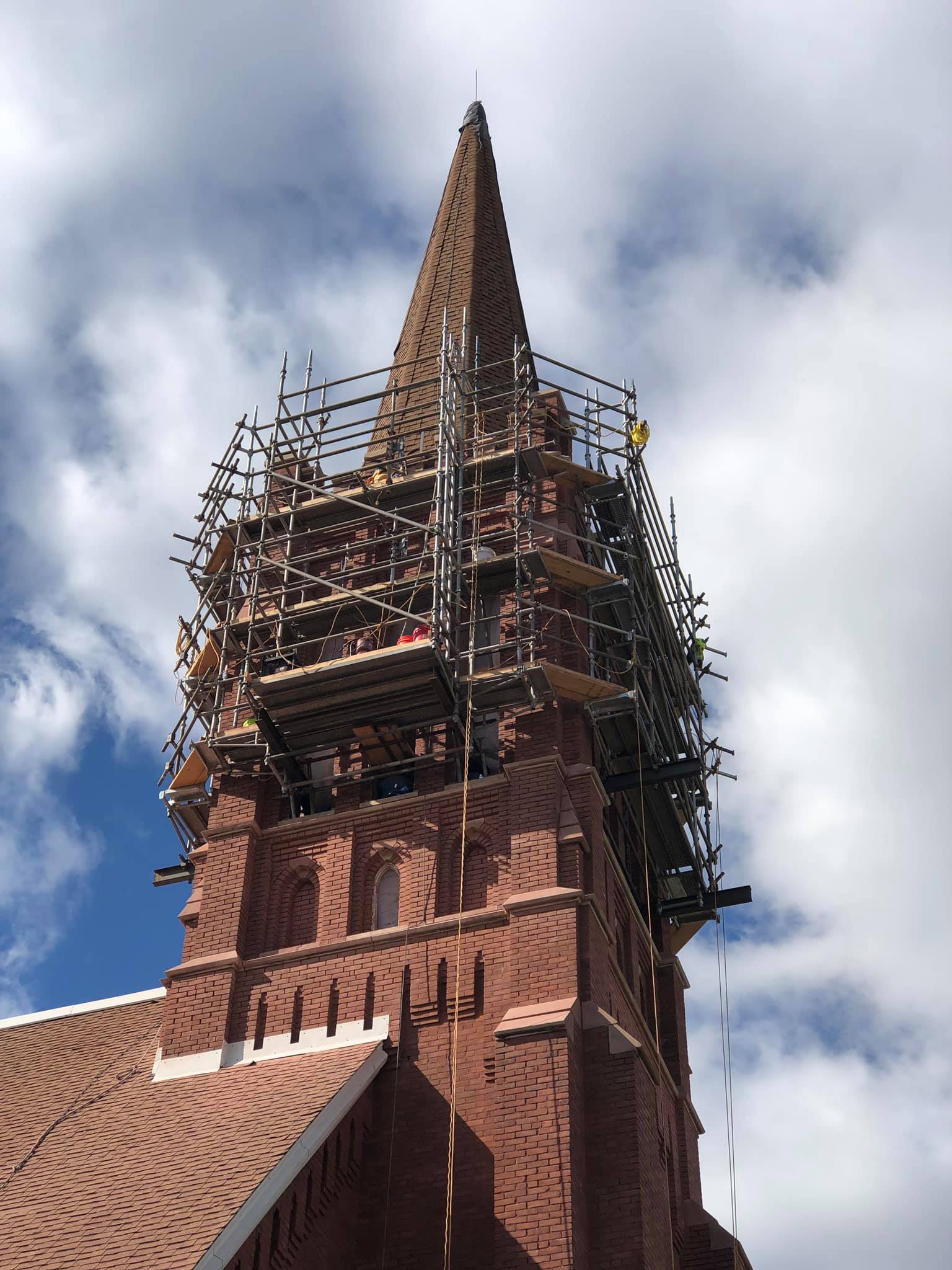 A large brick tower with scaffolding around it