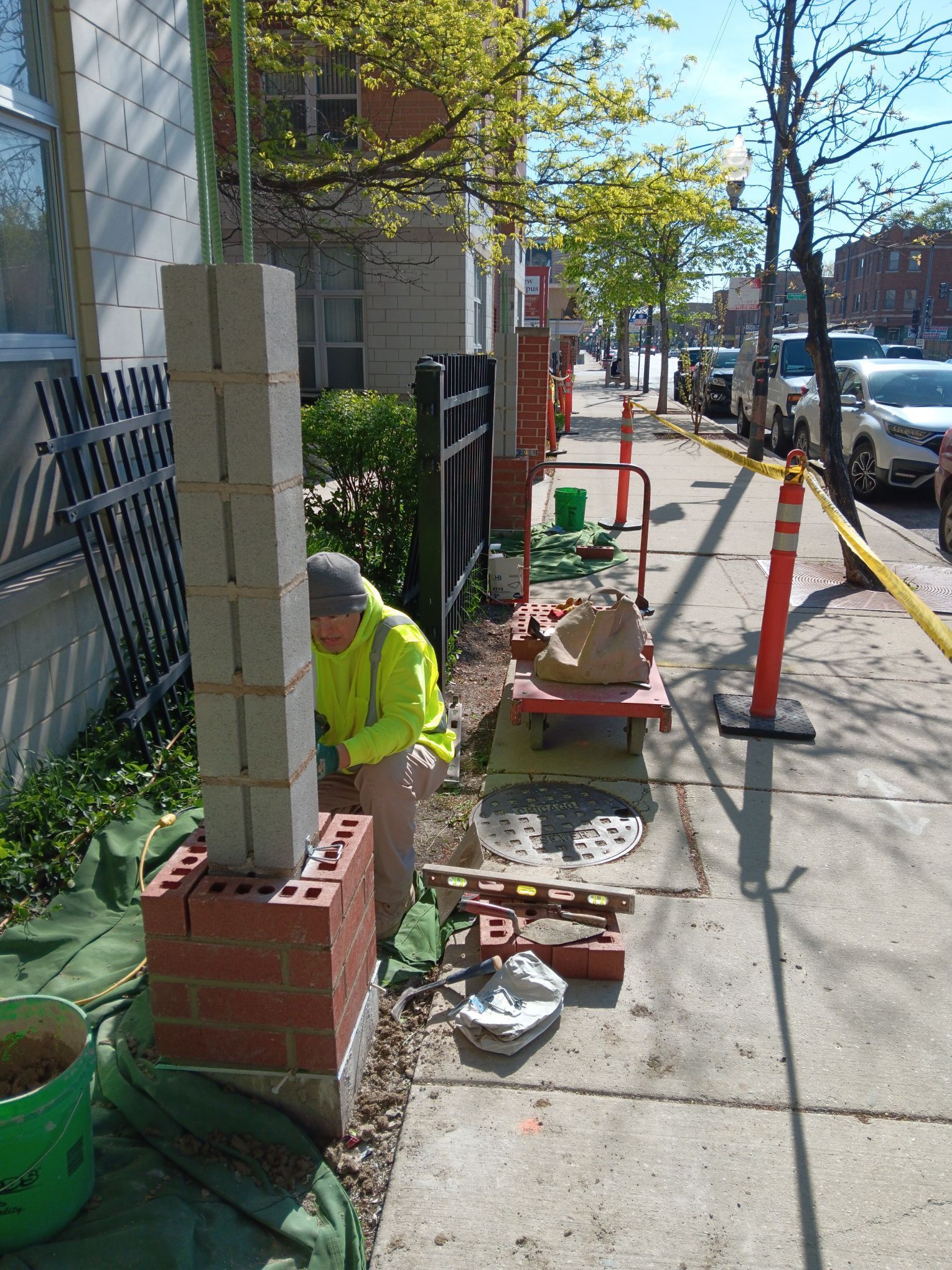 A man is replacing a brick column at Churchview Living.