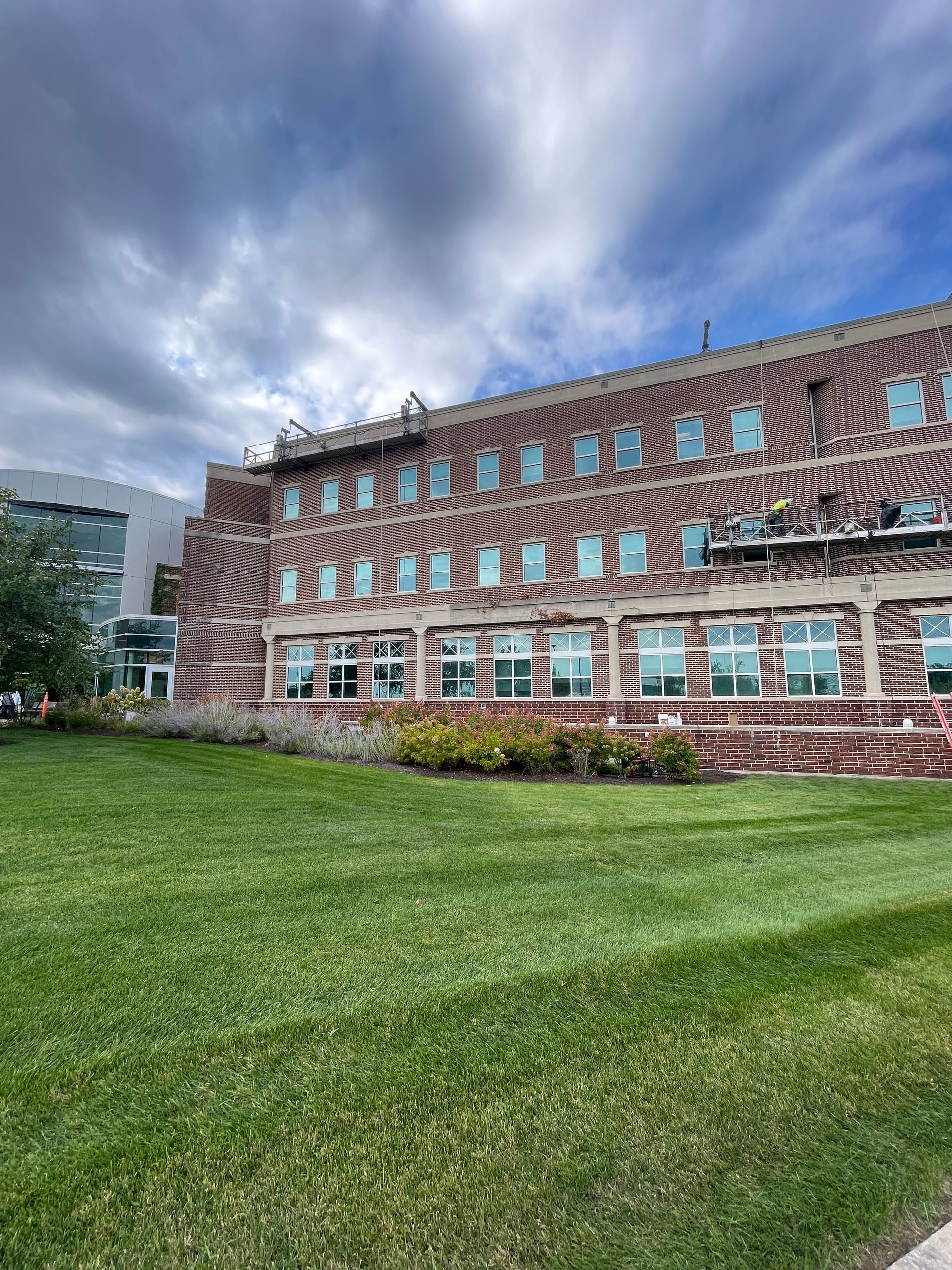 people on scaffolding repairing facade at Delnor hospital