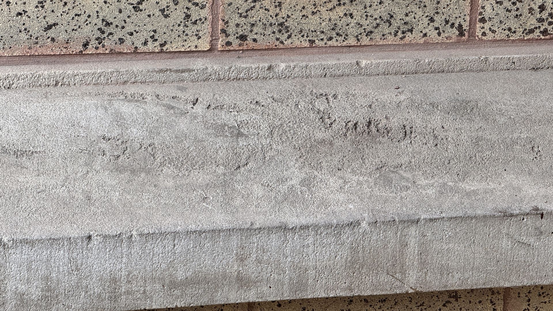 Example of concrete and masonry surface damage caused by excessive pressure washing, illustrating improper cleaning technique risks.