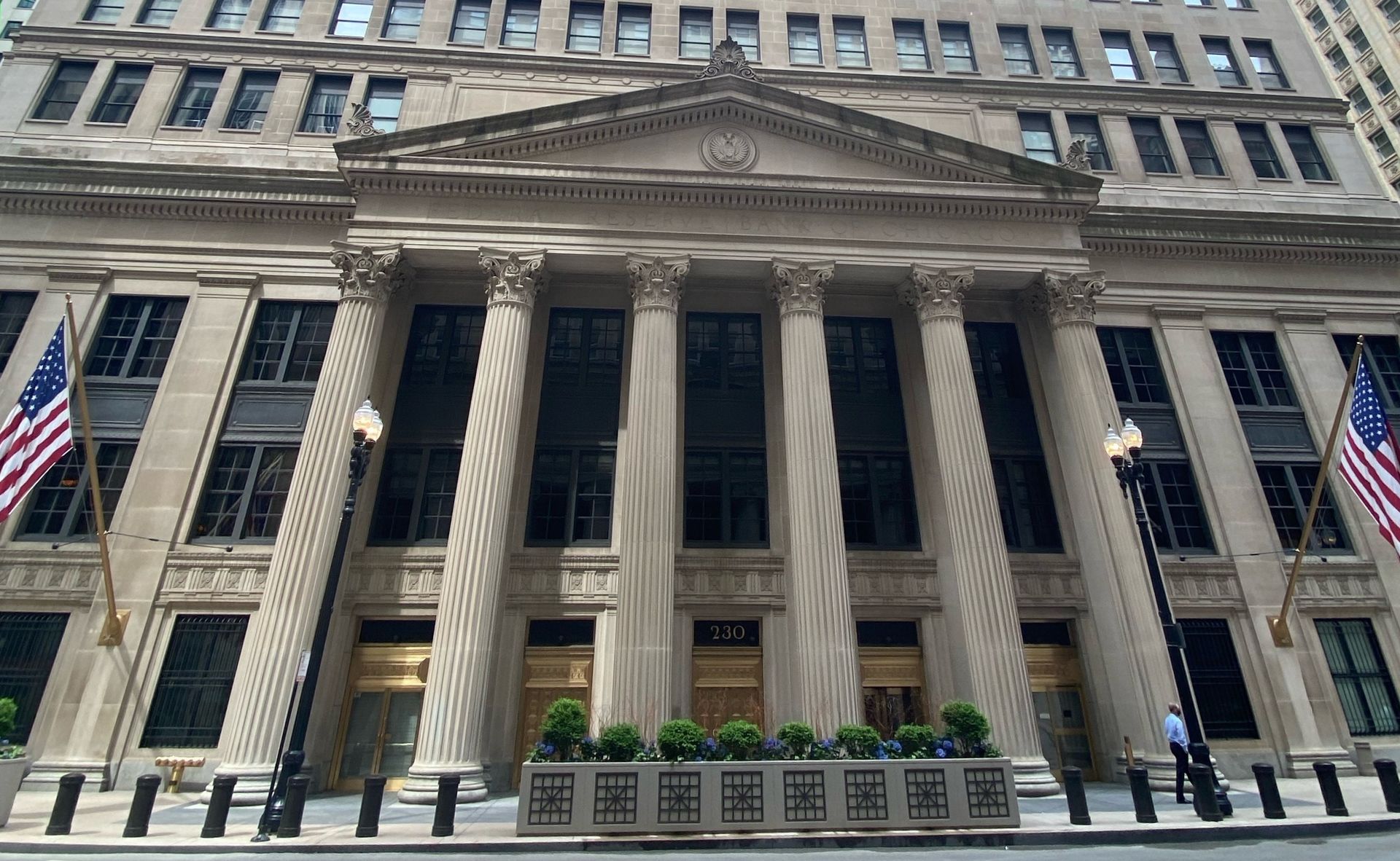 Front view of the historic Federal Reserve Bank of Chicago featuring classical stone columns and well-maintained limestone façade, highlighting the importance of exterior preservation for landmark buildings.