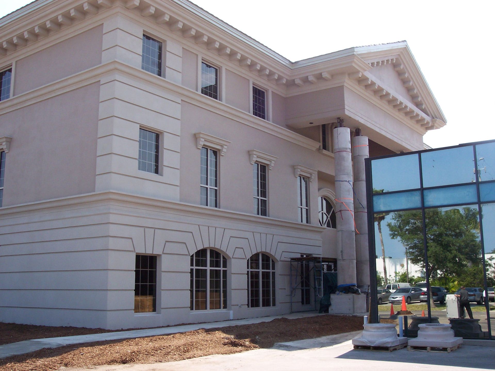 Exterior view of a neoclassical-style commercial bank under restoration
