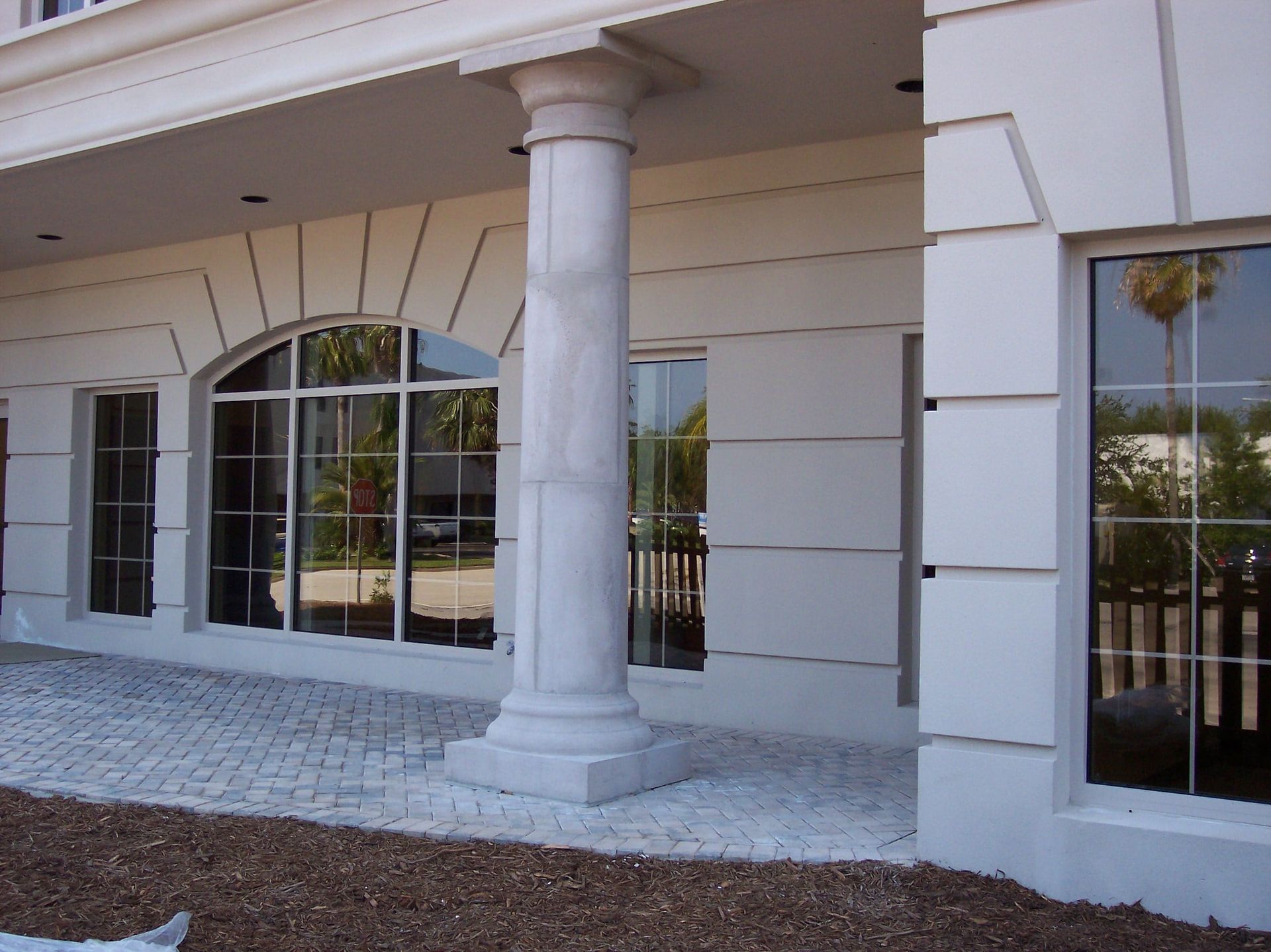 RestoreWorks inspection photo showing a discolored architectural column at a commercial bank façade, highlighting early signs of staining and weather-related wear.