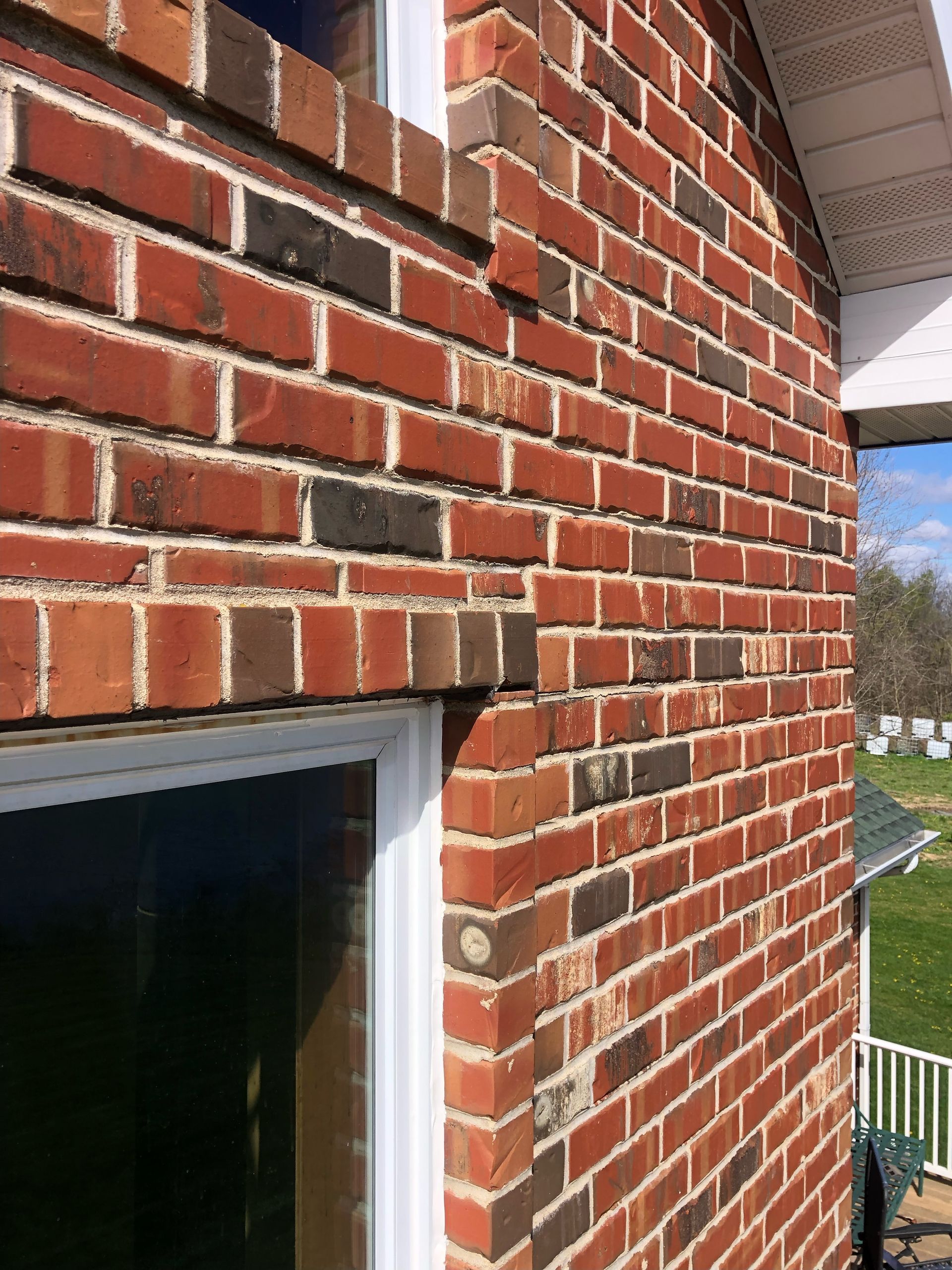 A close up of a brick wall with a window on it.