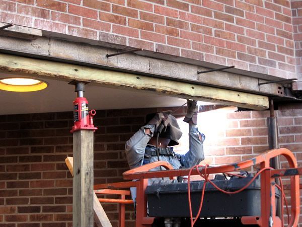 RestoreWorks craftsmen replace the lintel above a door opening on a commercial building. 