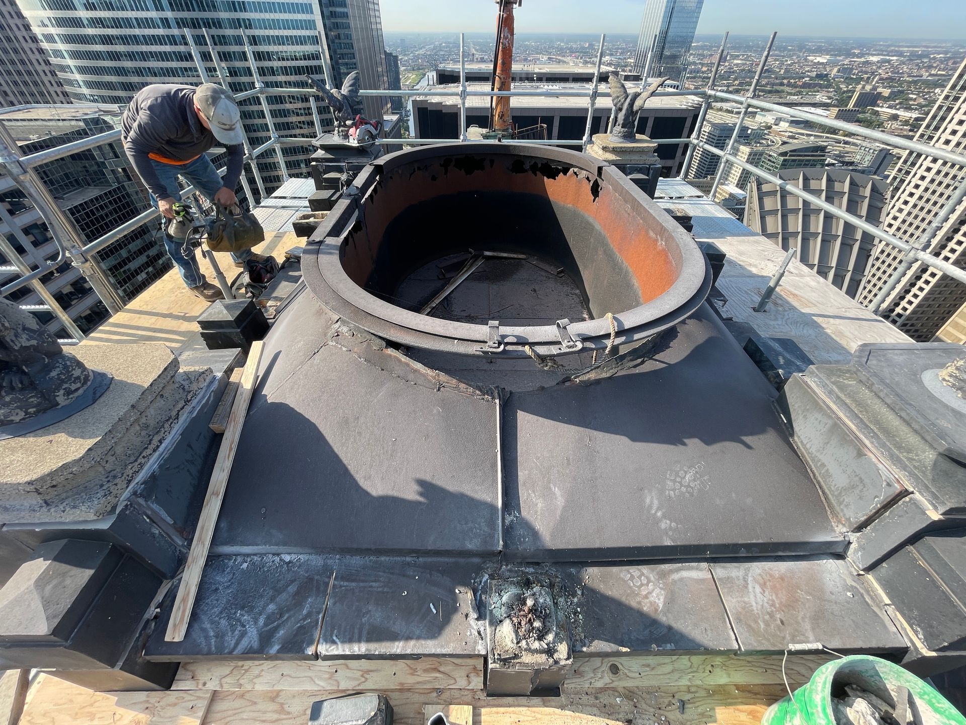 A man is working on a large metal structure on top of the Chicago Civic Opera House
.