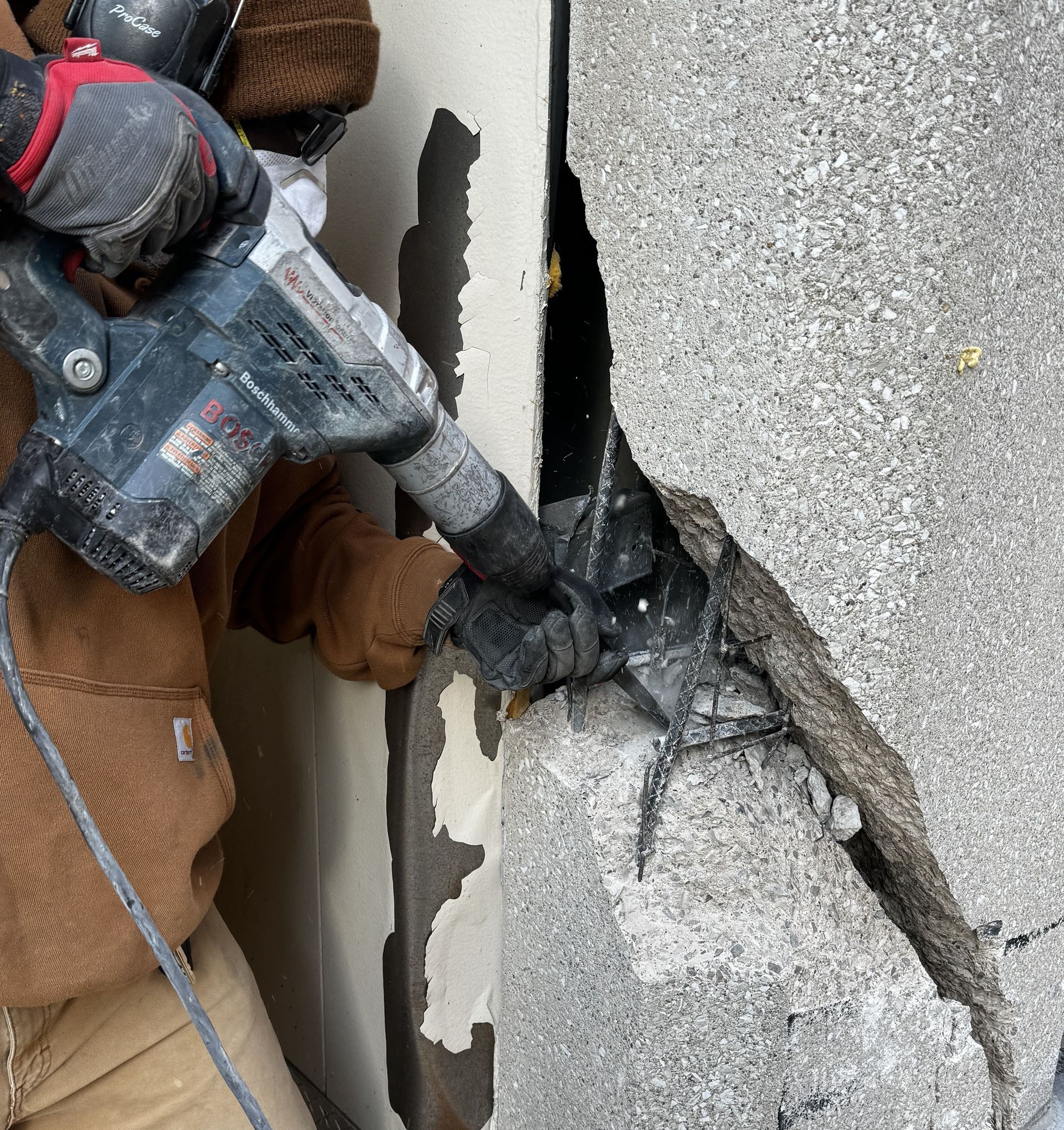 RestoreWorks technician performing controlled demolition to expose rebar during concrete restoration at the Sheraton Grand Chicago Riverwalk.