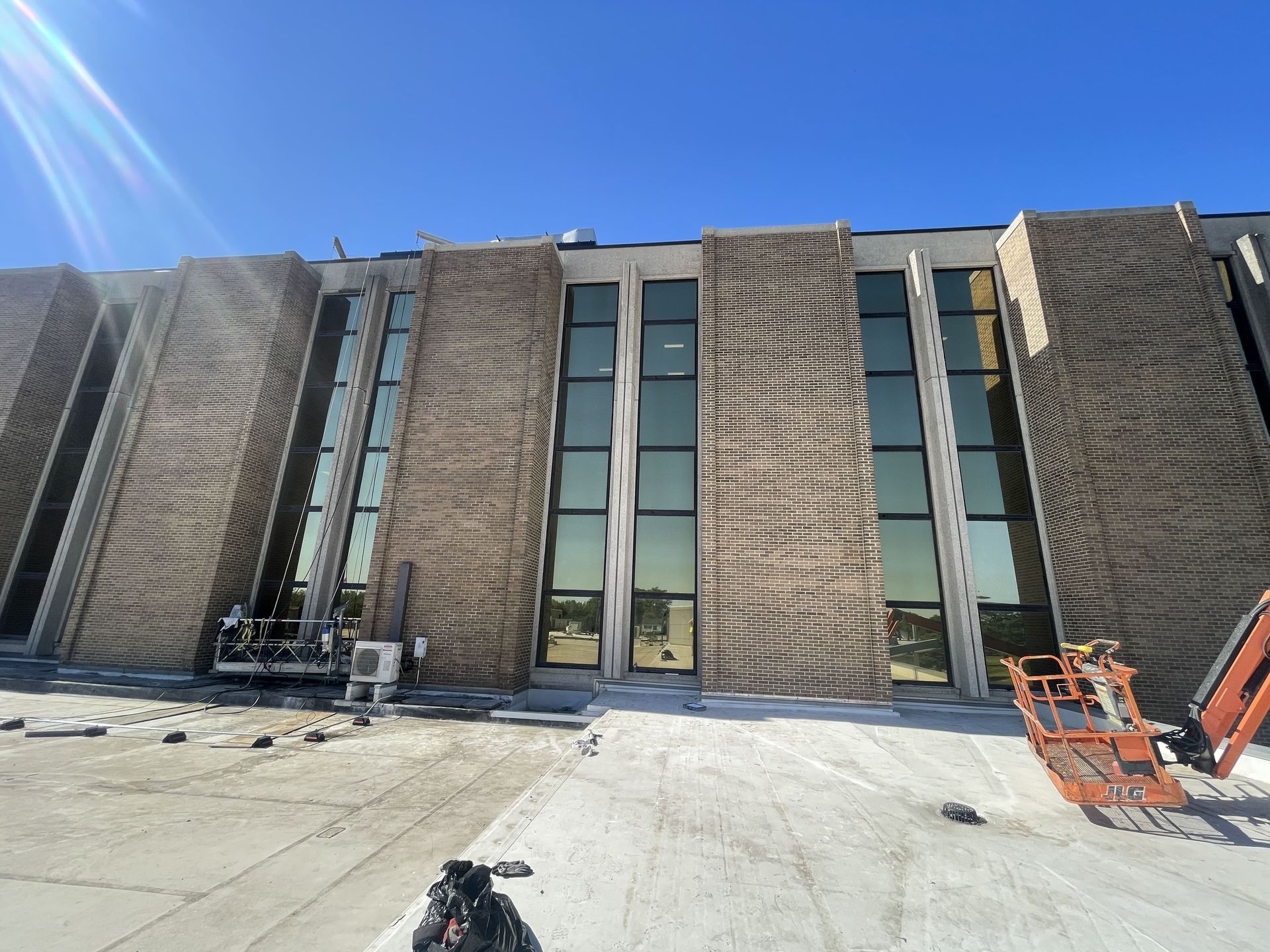 RestoreWorks crews performing exterior masonry and sealant restoration at Advocate South Suburban Hospital using a swing stage to reduce disruption to patient areas.