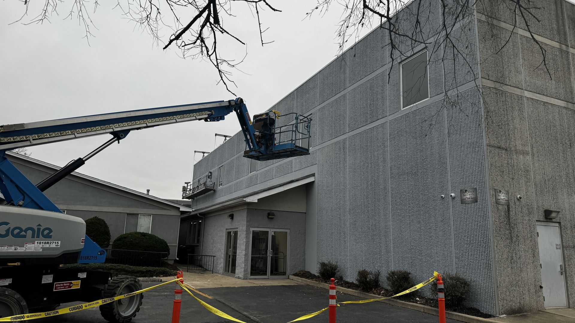 Boom lift used for exterior masonry restoration at Calvary Academy in South Holland, including sealant replacement and coatings.