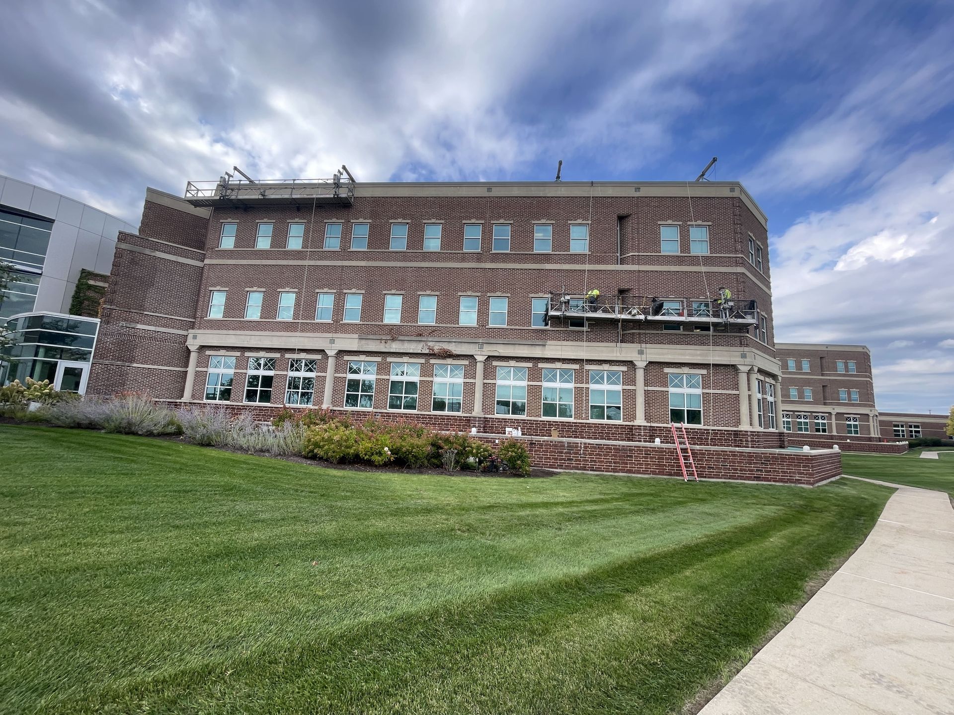 RestoreWorks crew performing facade restoration at Delnor-Community Hospital, including tuckpointing, caulking, and precast repairs with minimal disruption to operations.