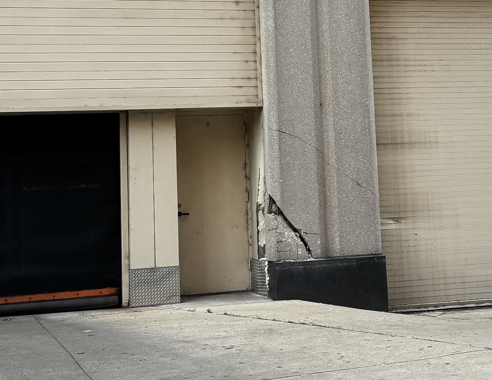 Cracked concrete column at the Sheraton Grand Chicago Riverwalk showing damage from vehicular impact prior to restoration work.
