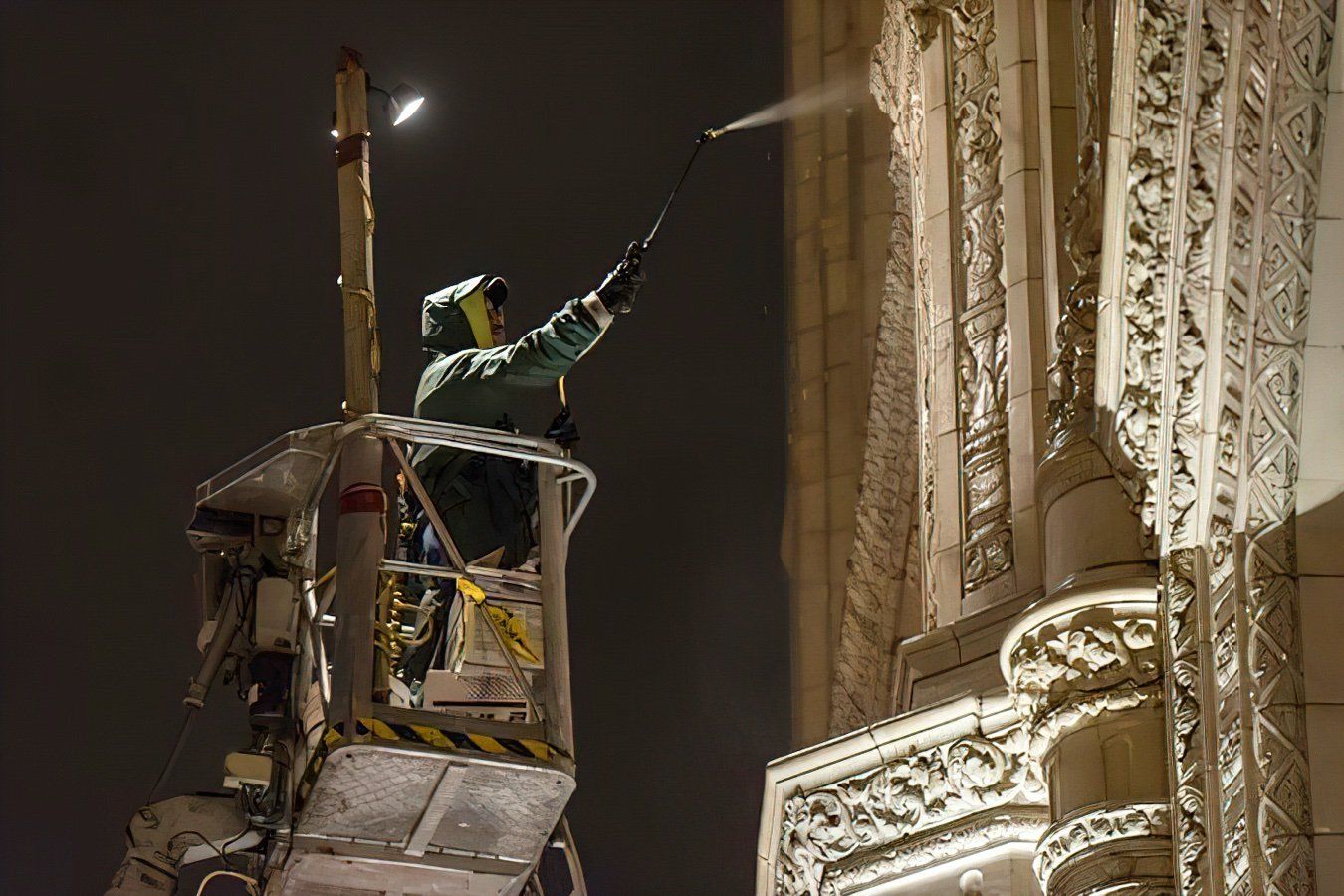 a ma is cleaning the Wrigley building at night