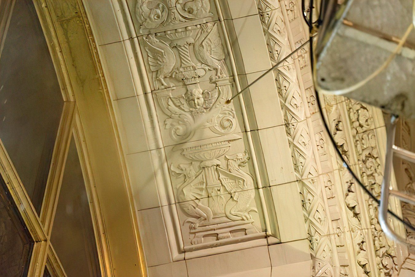 Aman is cleaning intricate stonework on the Wrigley building