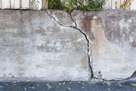 Cracked concrete wall showing damage likely caused by prolonged summer heat and thermal expansion. Without proactive maintenance, such cracks can spread and compromise structural stability.