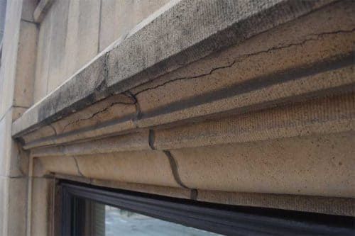 Cracked historic terracotta from structural movement and water infiltration, showing need for timely masonry repairs to prevent further deterioration.