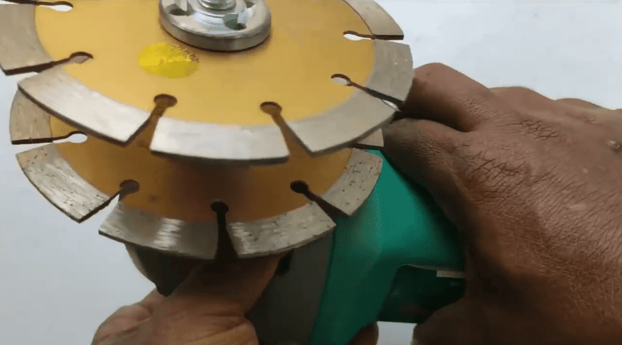 Close-up of a double-blade grinder used in masonry restoration for precision cutting, patch preparation, and color matching during stone and mortar repairs.