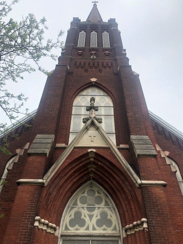 Front facade of St. Joseph's church with the steeple and a cross on it