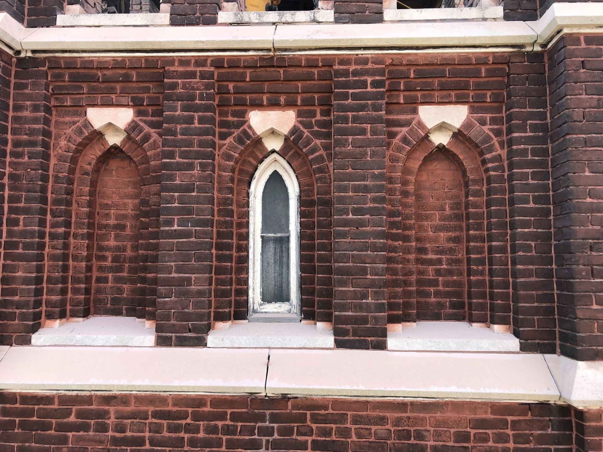 A brick building with arched windows on the side