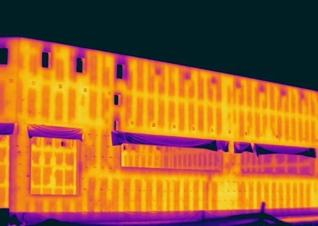 Infrared thermography scan of commercial building showing heat loss and insulation gaps.