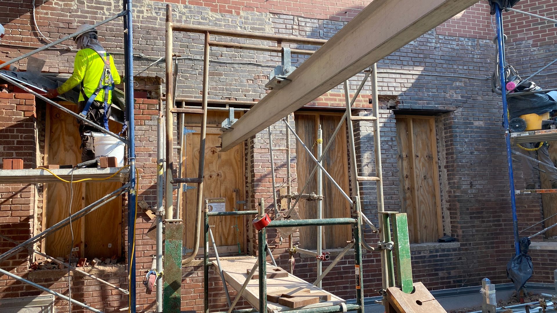 scaffolding in front of a brick building.