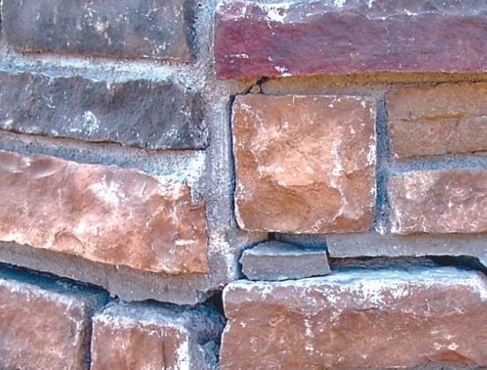 Close-up of cracked and powdery mortar joints in a brick wall showing early tuckpointing failure and moisture entry risk.