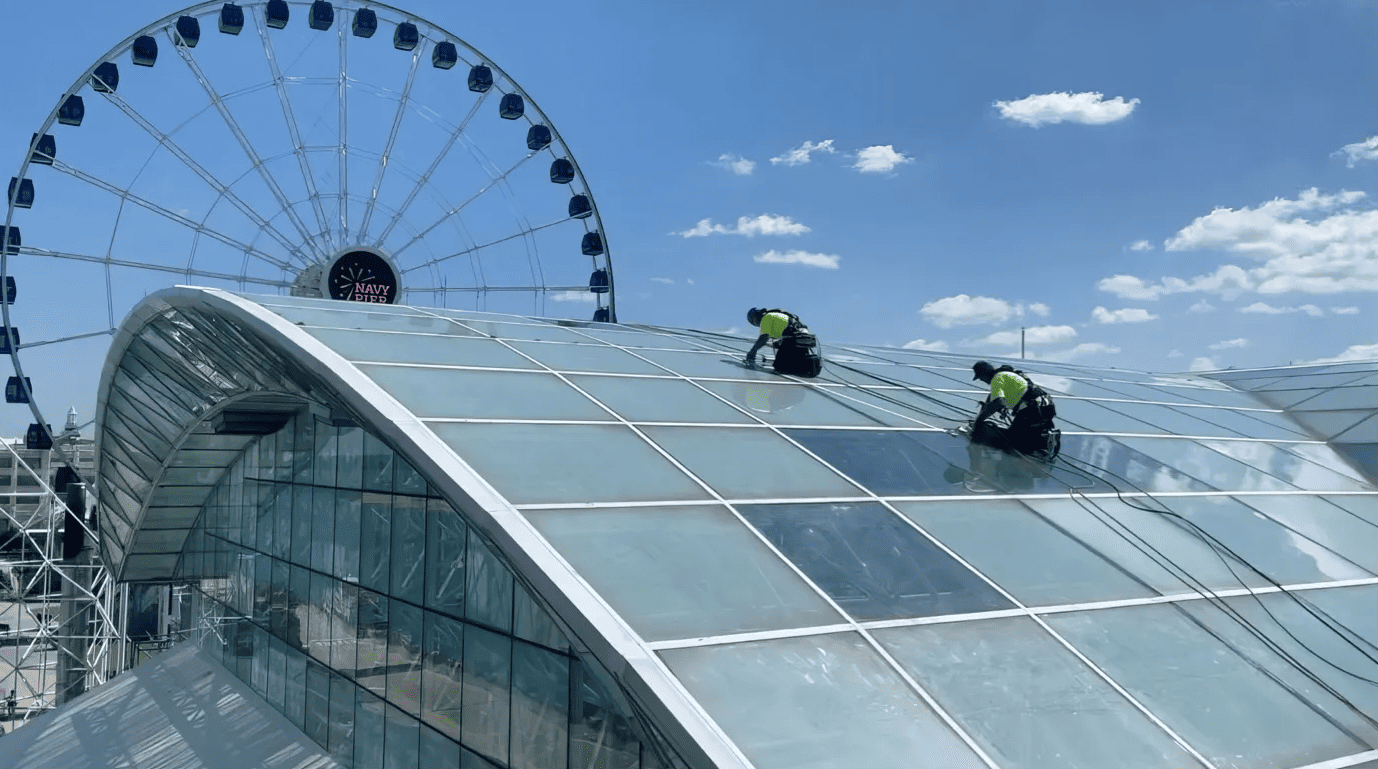 RestoreWorks crew using industrial rope access to perform sealing on Navy Pier’s Crystal Garden glass structure in Chicago.