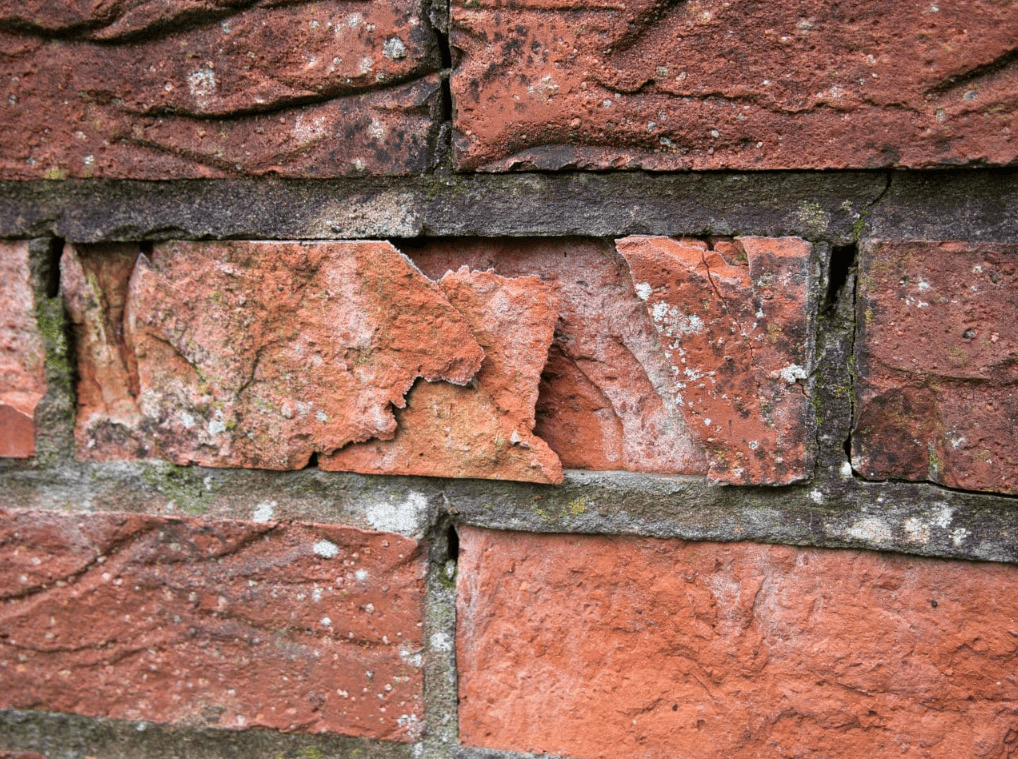 Brick spalling and masonry deterioration caused by moisture retention and freeze–thaw cycles