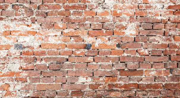 Red brick wall with white mortar showing age and weathering.