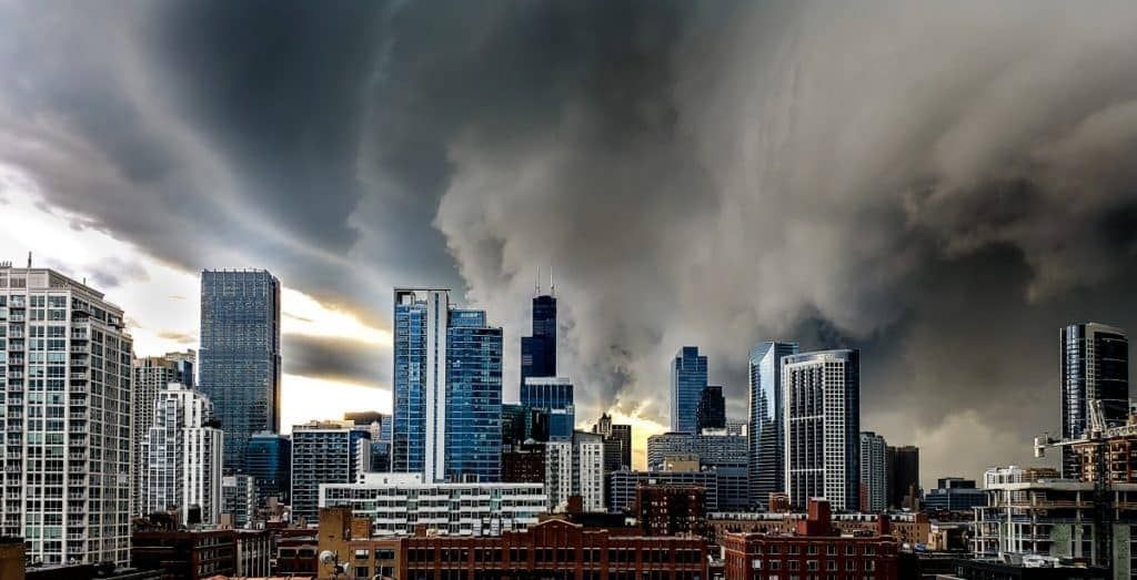 Severe summer storm approaching downtown Chicago skyline, dark clouds forming over buildings