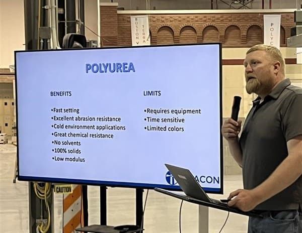 Presenter from the International Masonry Institute discussing the benefits and limitations of polyurea sealants at the sealant station during RestoreWorks’ hands-on masonry restoration workshop.