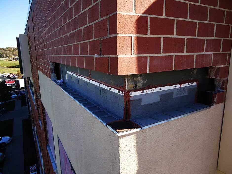 RestoreWorks installing new thru-wall flashing beneath a brick facade.