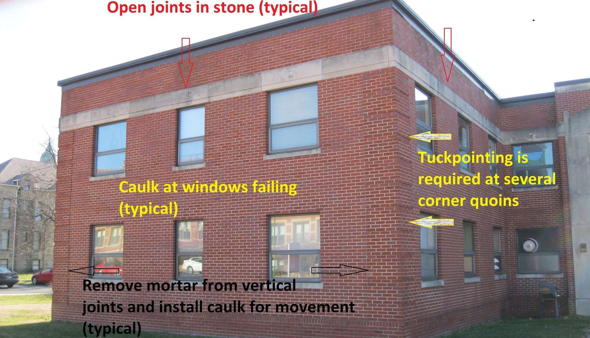 Brick building with multiple masonry issues identified during RestoreWorks inspection, including failing window caulk, open stone joints, and tuckpointing needs at corner quoins.