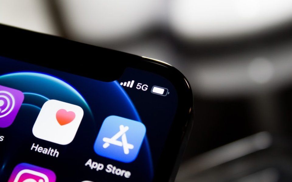 A close up of a cell phone with the app store icon on the screen.