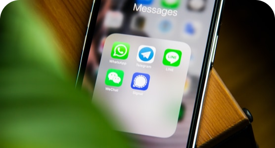 A close up of a cell phone displaying the messages app.