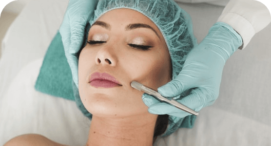 A woman is getting a facial treatment at a beauty salon.