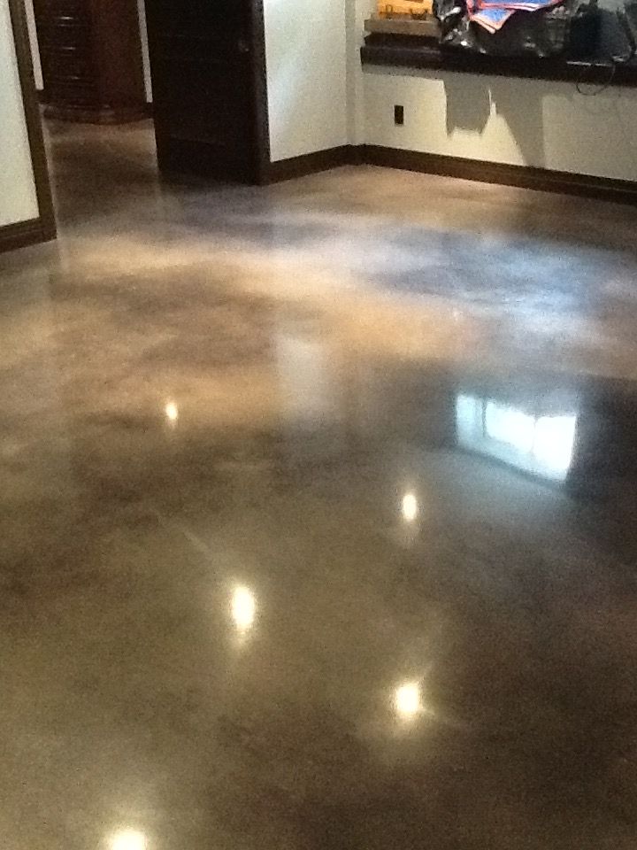 A shiny concrete floor in a room with a window
