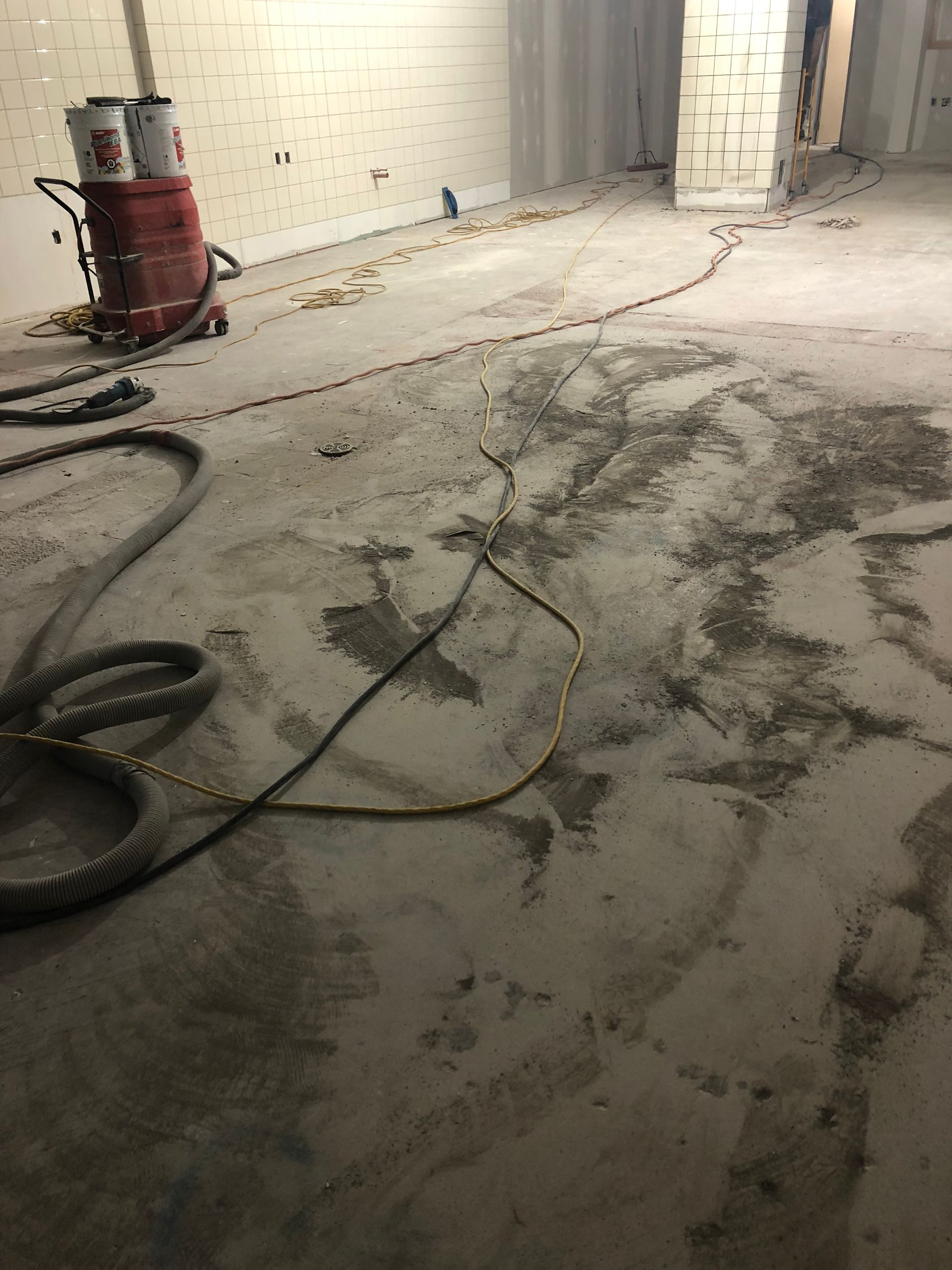 A vacuum cleaner is sitting on the floor of a room.