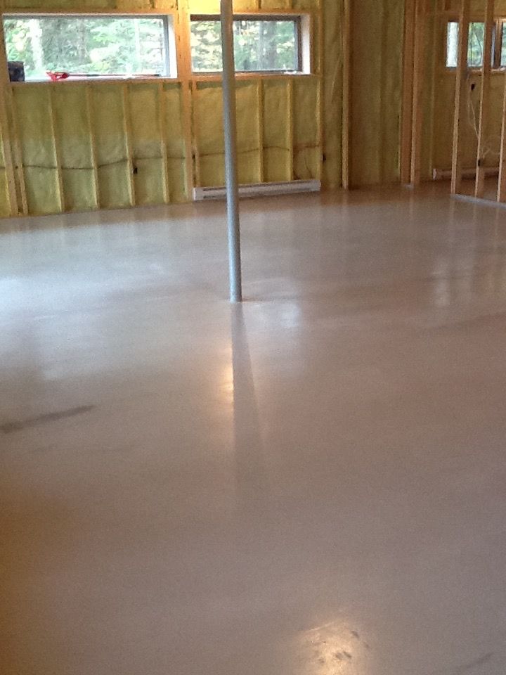 A room with a concrete floor and a pole in the middle of it.