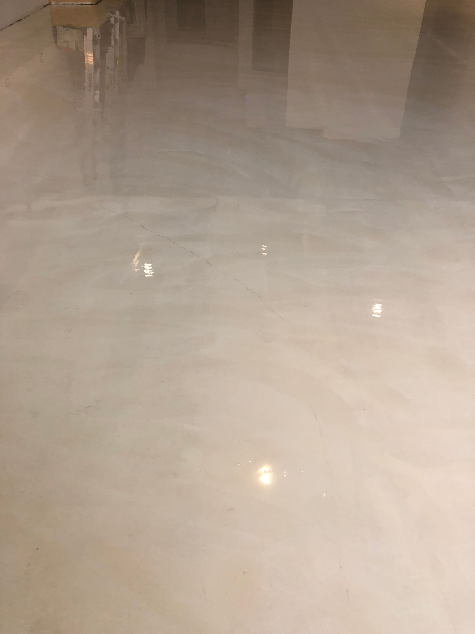A close up of a white marble floor in a room.