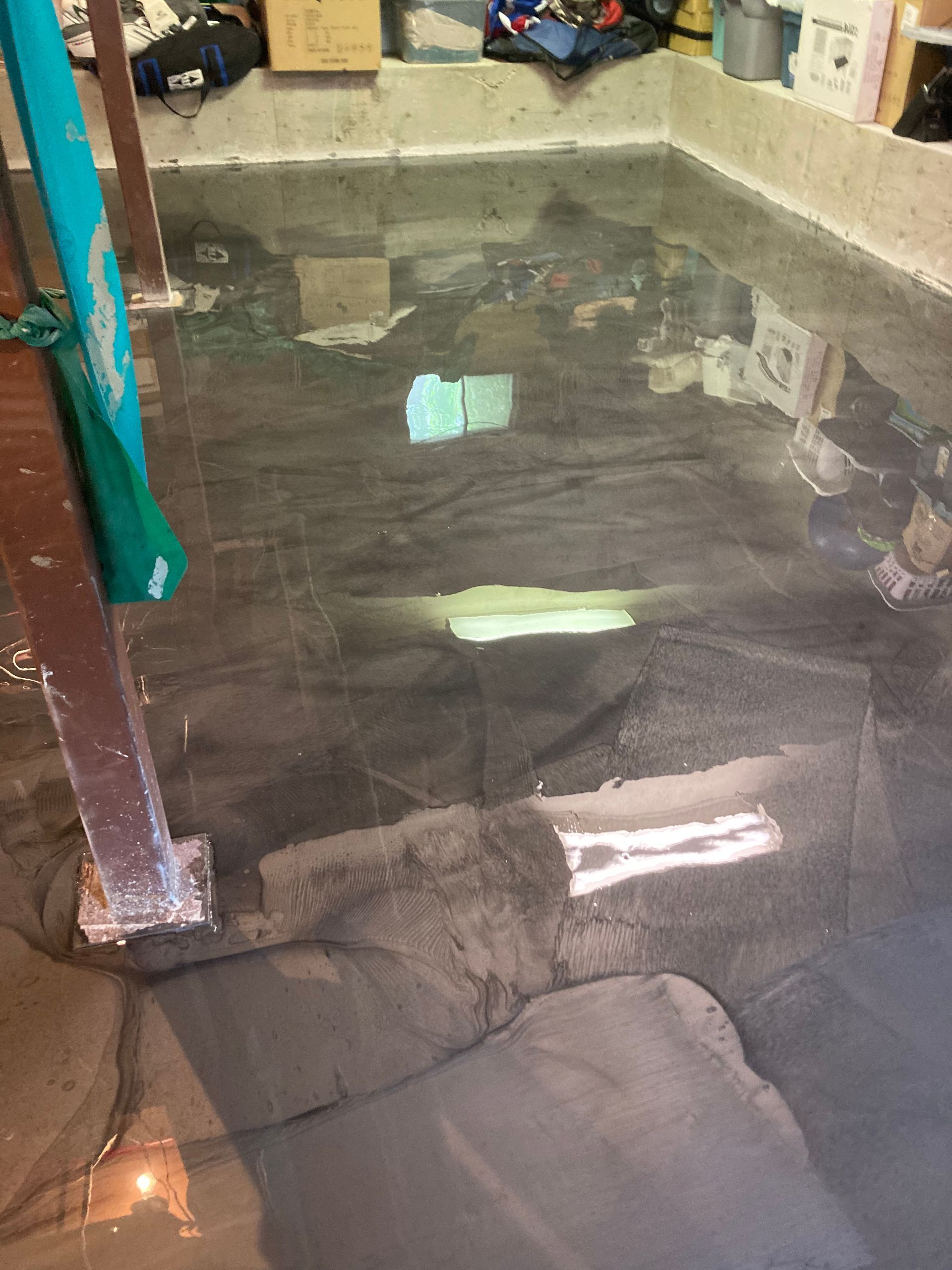 A flooded basement with a lot of water on the floor.
