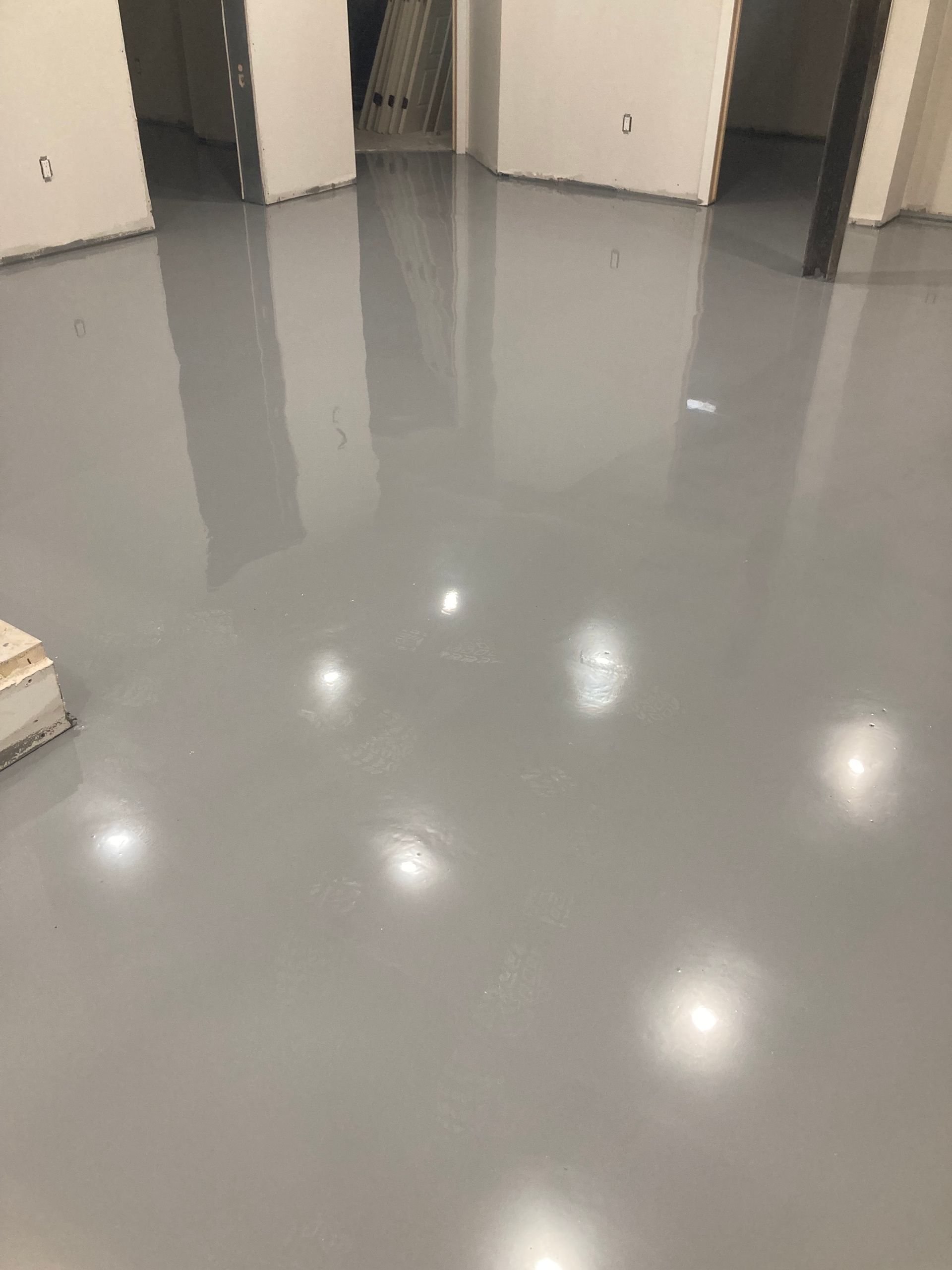 A room with a gray floor and white walls.