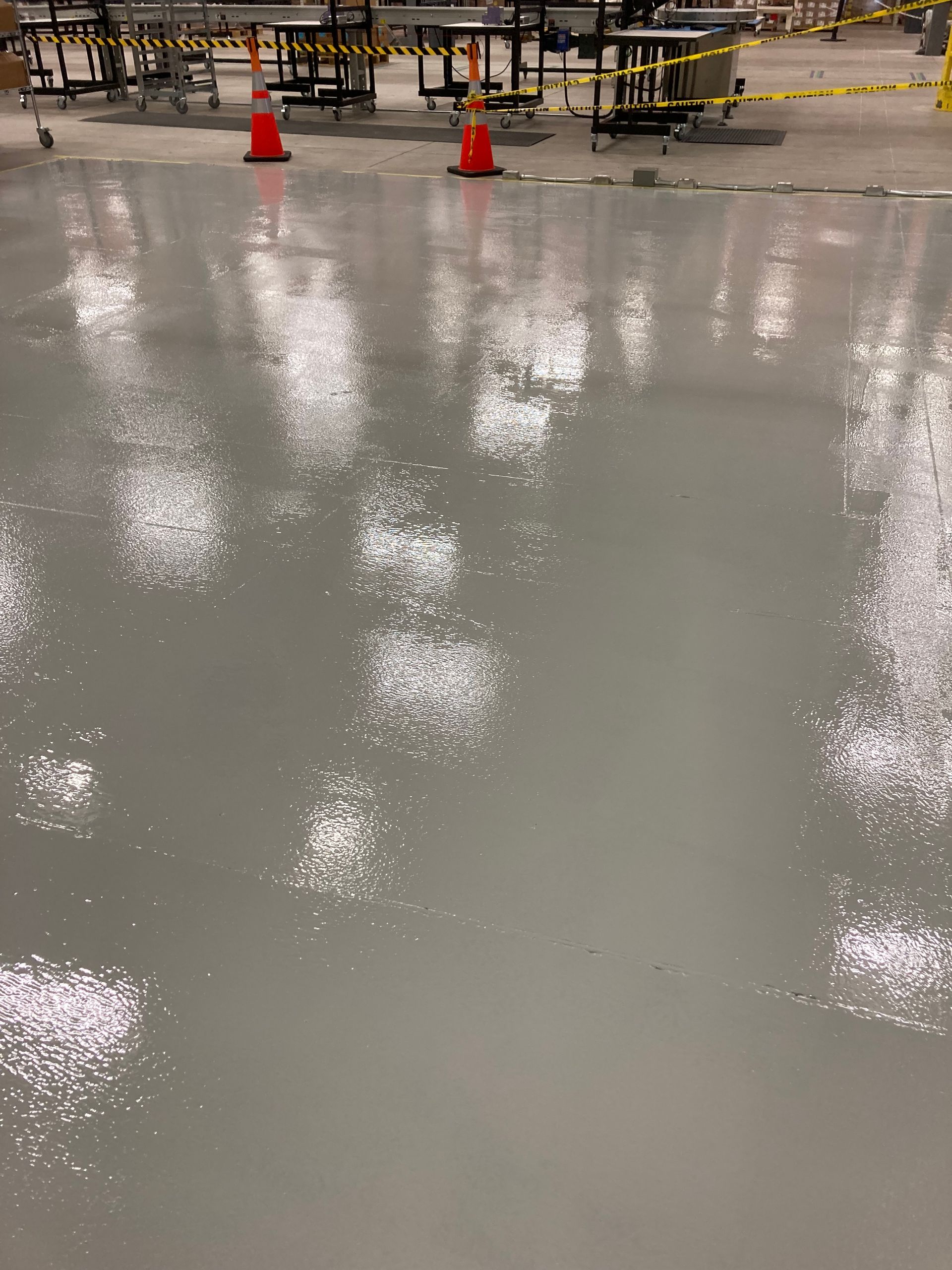 A warehouse floor with a lot of cones on it