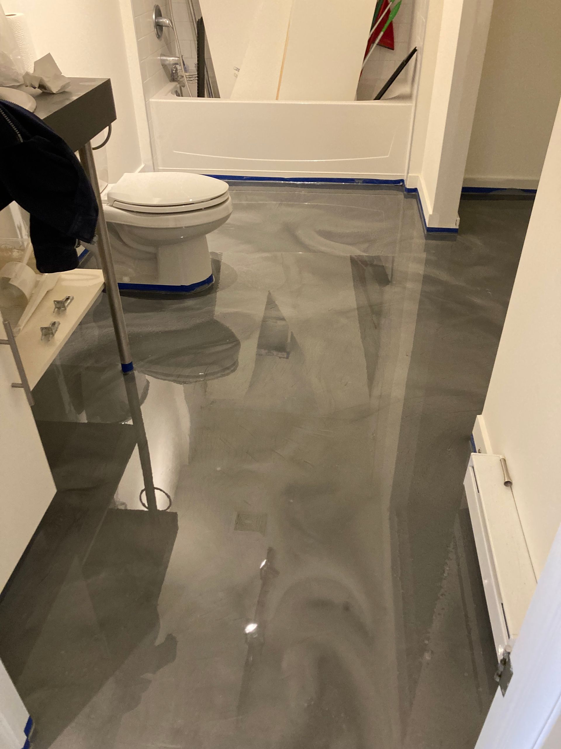 A bathroom with a toilet , sink , and bathtub.