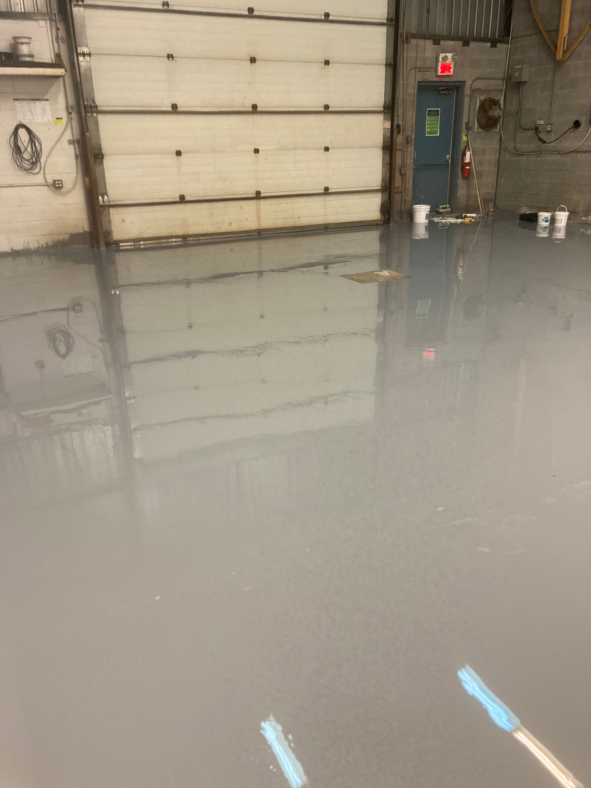 A garage with a concrete floor and a garage door.