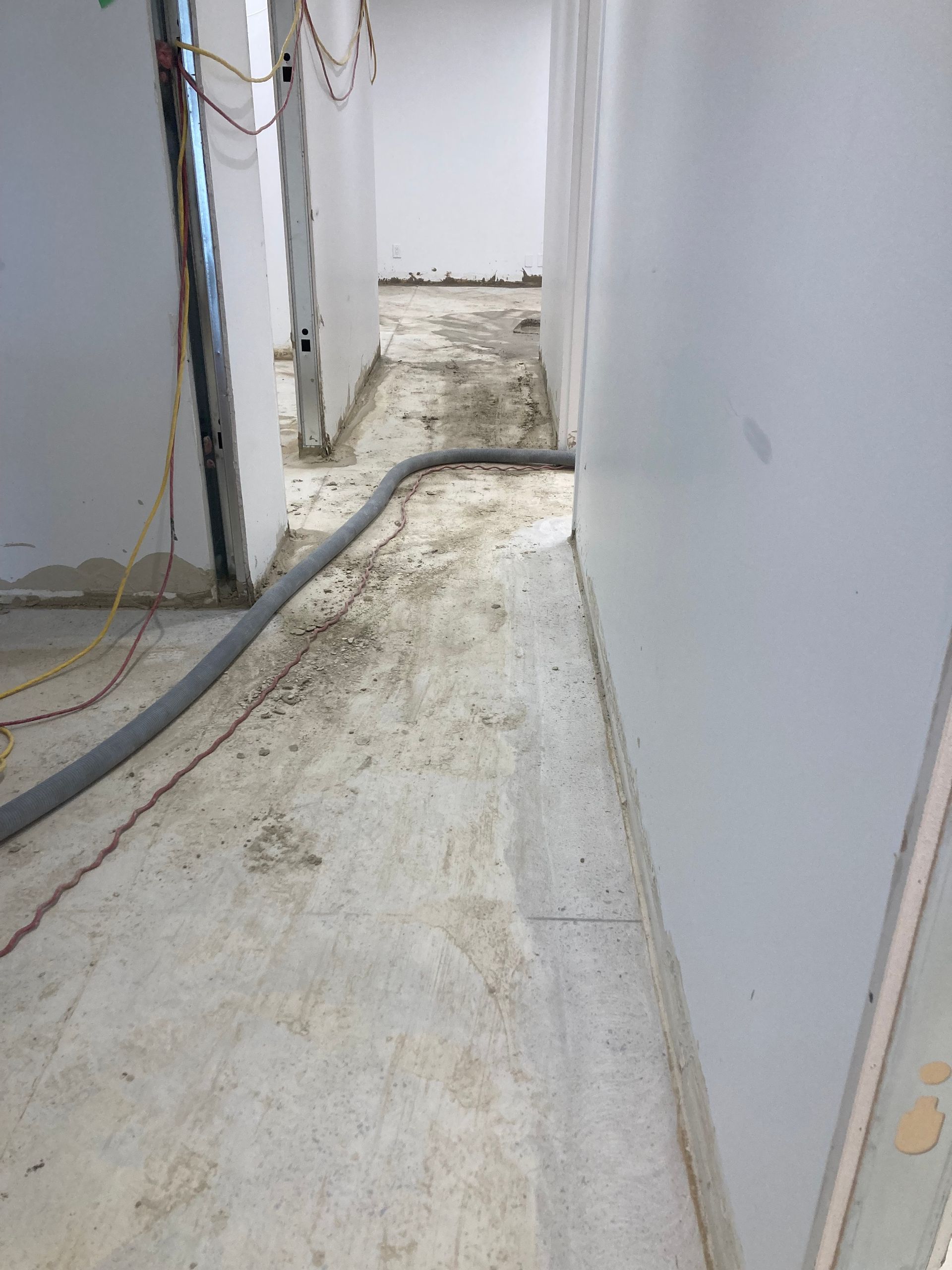 A long hallway with a hose in the middle of it.