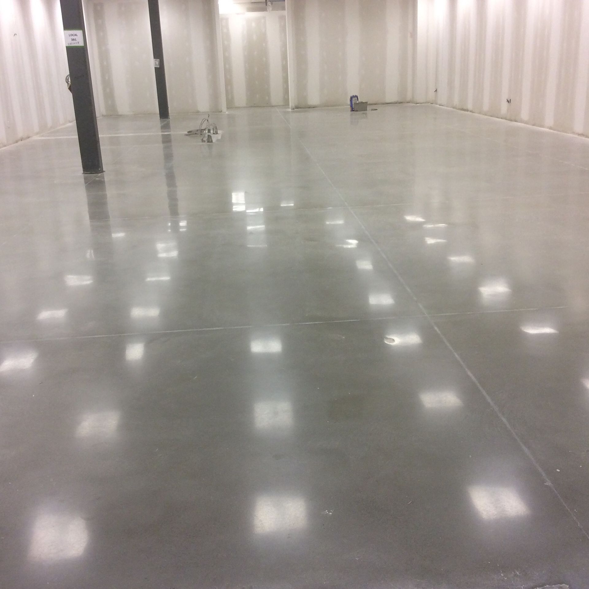 A large empty room with a shiny concrete floor