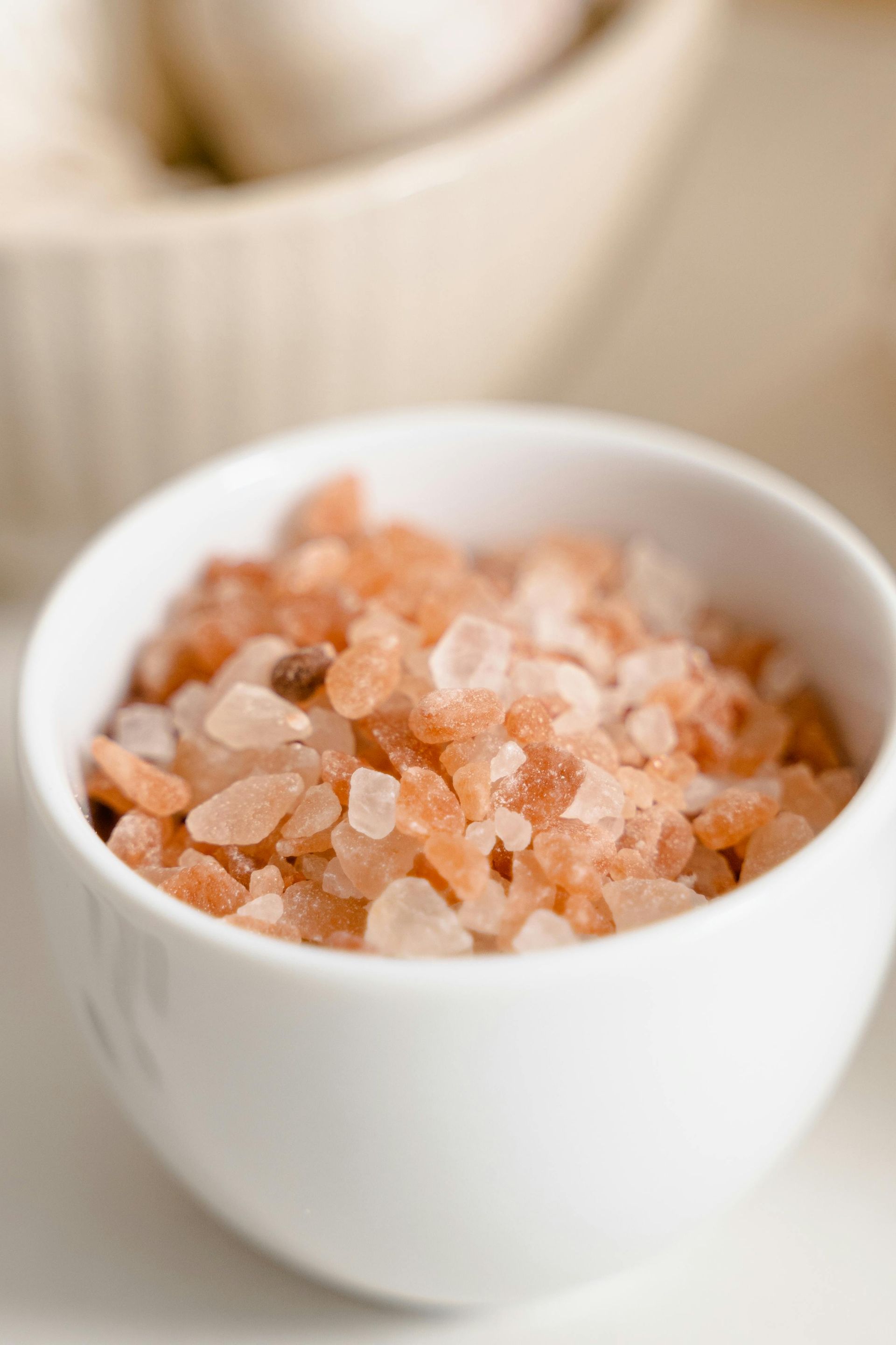 Pink Himalayan salt in a small white bowl.